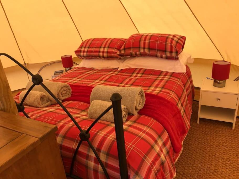 a bedroom with a bed in a tent at Cox Hill Glamping Benson in Truro