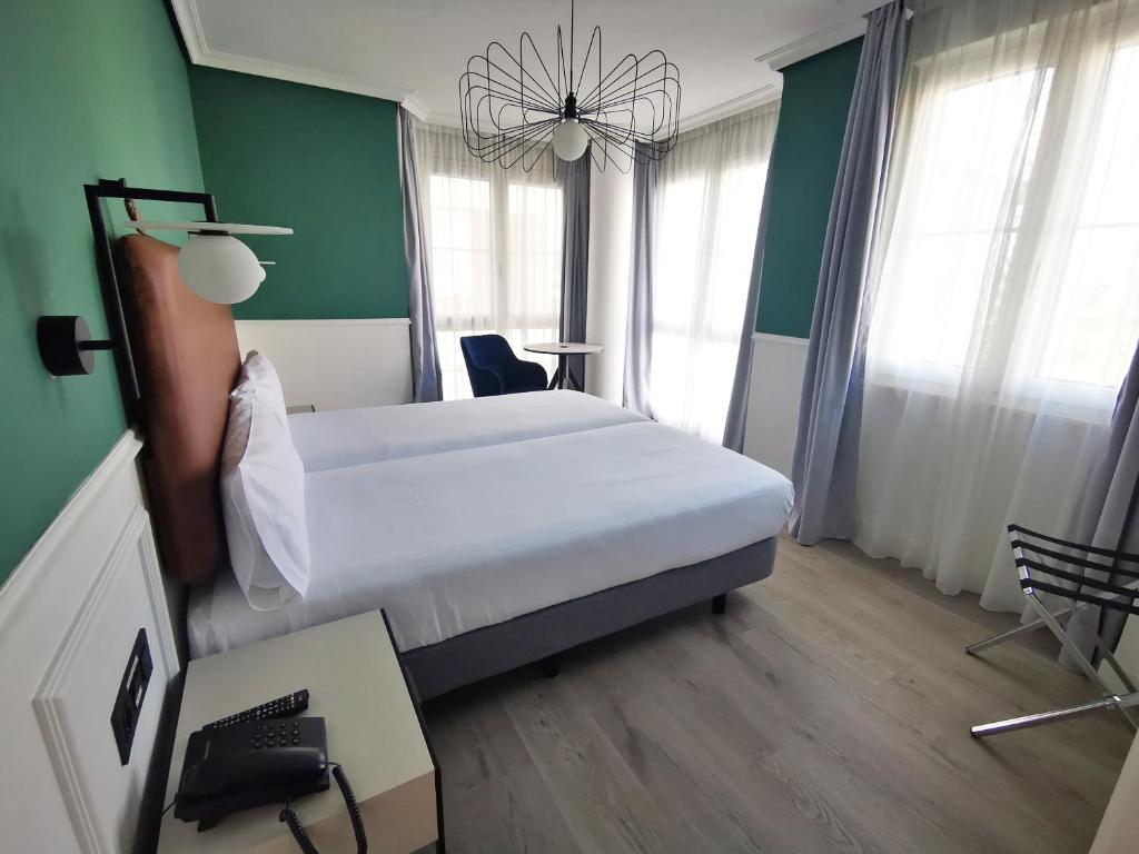 Postel nebo postele na pokoji v ubytování Hotel Don Rodrigo