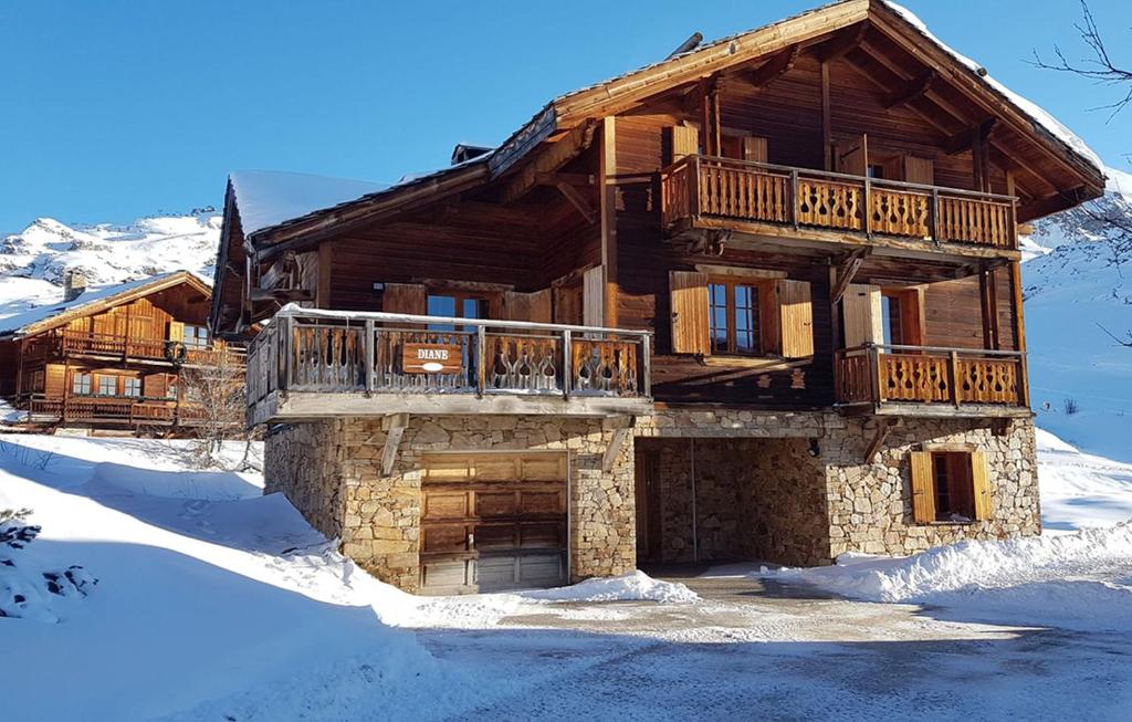 a log cabin in the snow with a balcony at Odalys Chalet Diane in L'Alpe-d'Huez