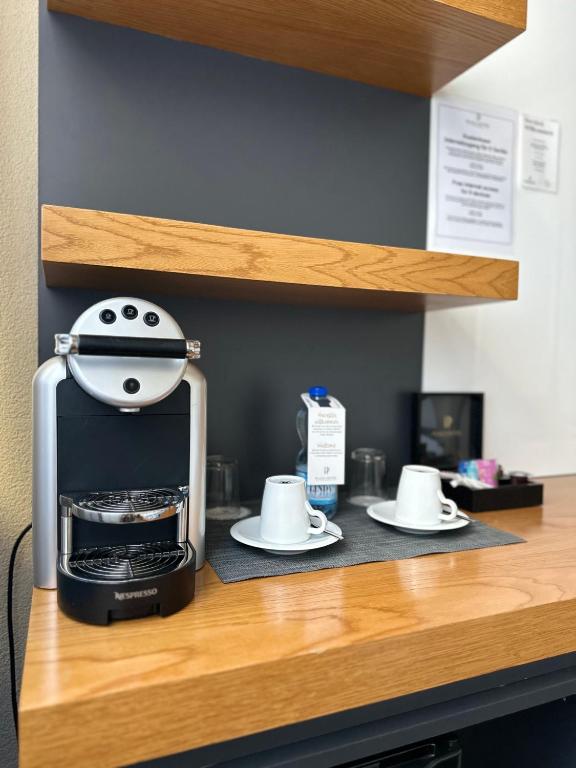 a coffee maker sitting on top of a counter at Plaza Hotel Winterthur in Winterthur
