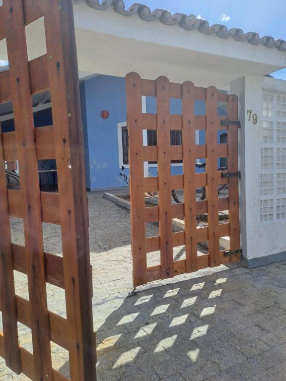a pair of wooden gates in front of a building at CASA AZUL in Peruíbe