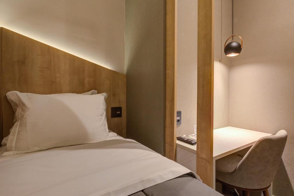 Ein Bett oder Betten in einem Zimmer der Unterkunft Fast Sleep Suites by Slaviero Hoteis - Hotel dentro do Aeroporto de Guarulhos - Terminal 2 - desembarque oeste