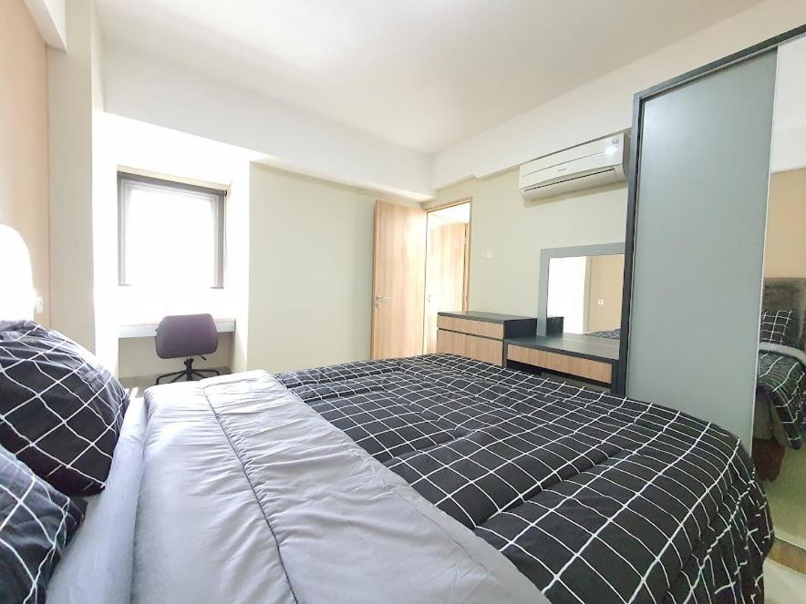 a bedroom with a large bed and a mirror at PADINA SUITES in Poris