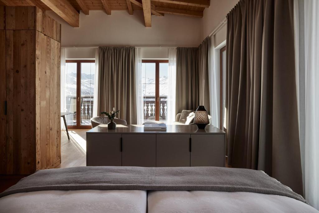 a bedroom with a bed and a large window at TOP Hotel Hochgurgl in Hochgurgl