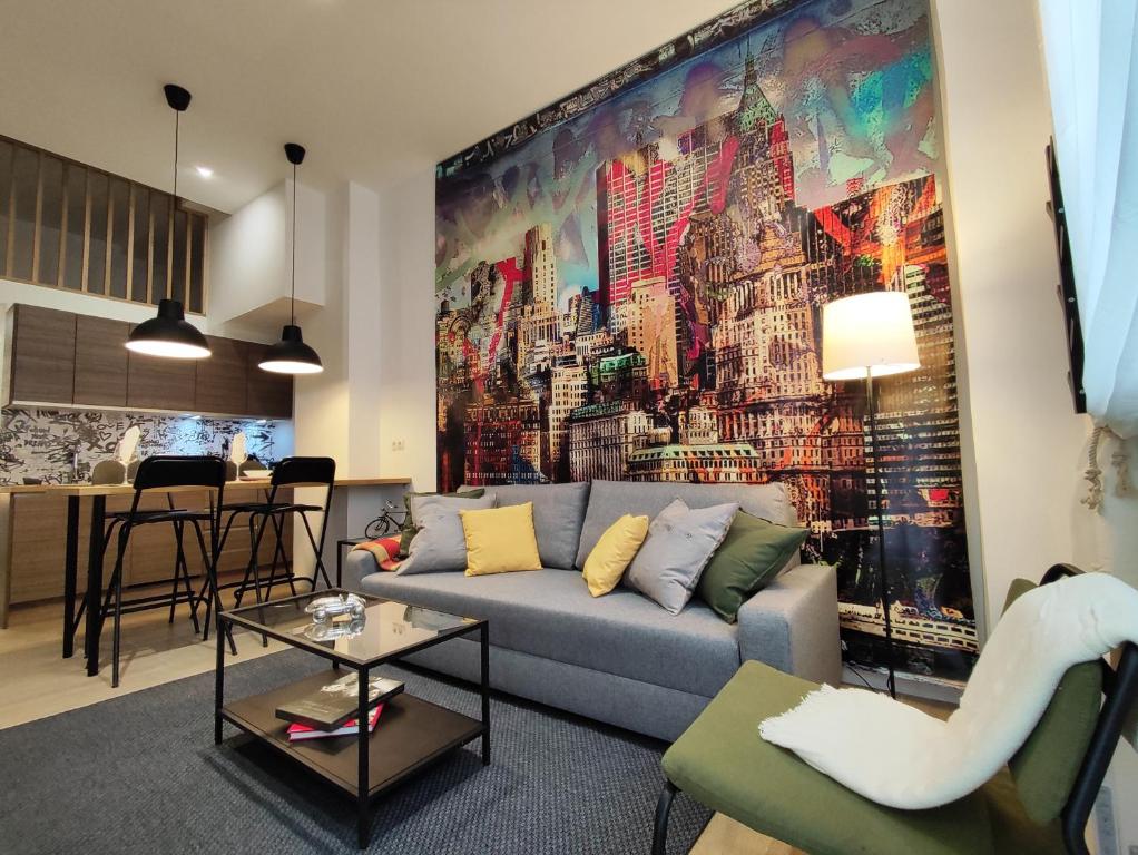 a living room with a large painting on the wall at Precioso apartamento en Puente Vallecas, Madrid. D in Madrid