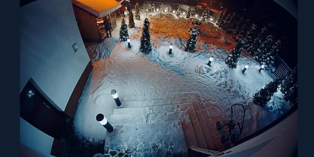 an overhead view of a street with snow and trees at Pensiunea Julian House in Moieciu de Jos