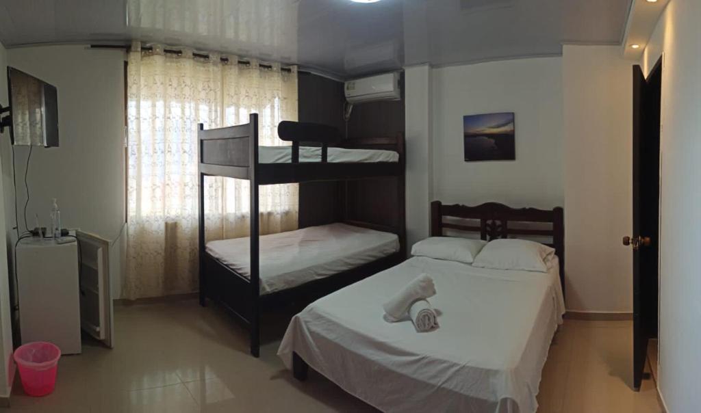 a bedroom with two bunk beds and a television at Zaida View in San Andrés