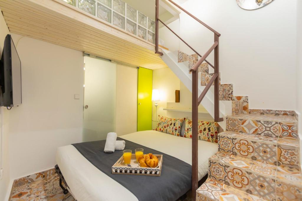 a bedroom with a bunk bed with a staircase at Almaden apartamento in Madrid