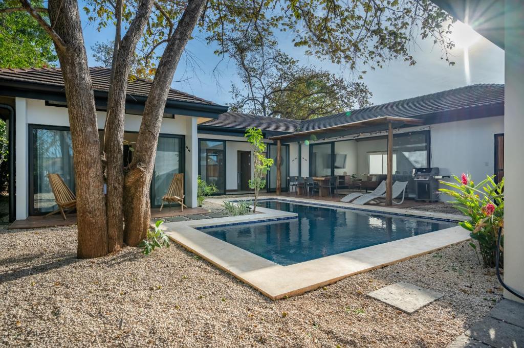 a swimming pool in the backyard of a house at Casa de Armonia in Tamarindo