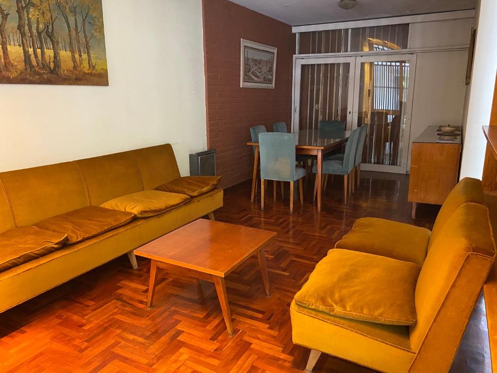 sala de estar con sofá, mesa y sillas en Casa en el Gran Mendoza en Mendoza
