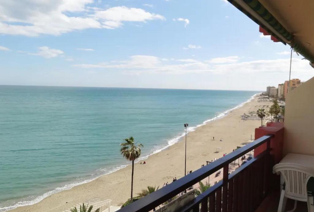 a view of the beach from a balcony at Mode's beachfront in Fuengirola
