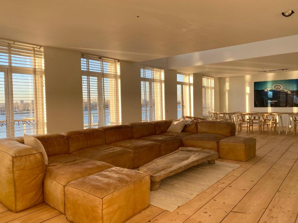 安特衛普的住宿－Loft O - River View，客厅配有棕色沙发和桌子