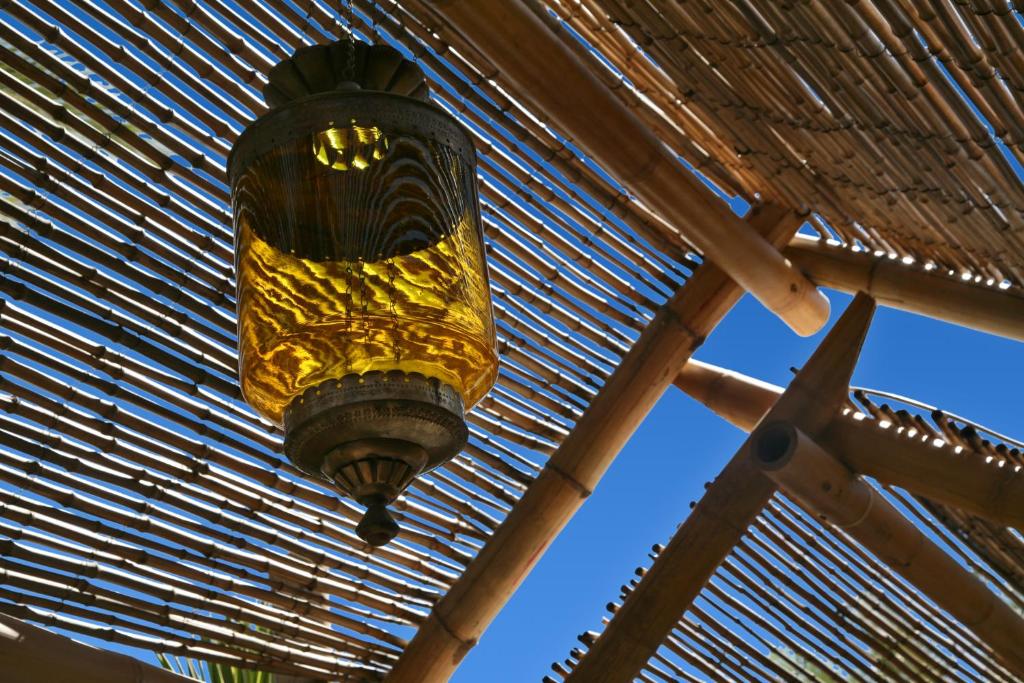 a chandelier hanging from a wooden roof at Oasi Beach Hotel in Vieste