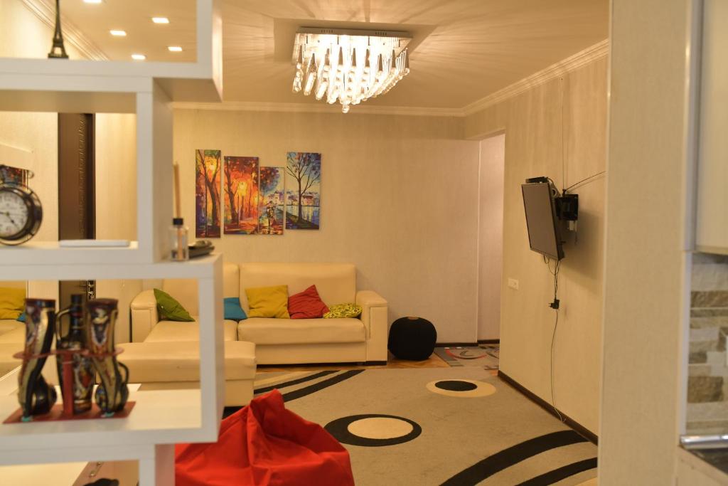 a living room with a couch and a television at Sweet Home in Kutaisi