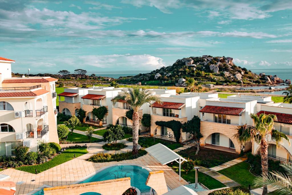 an aerial view of a resort with a mountain in the background at Fantastic 4 Cyprus First Line Beachfront in Boğaz