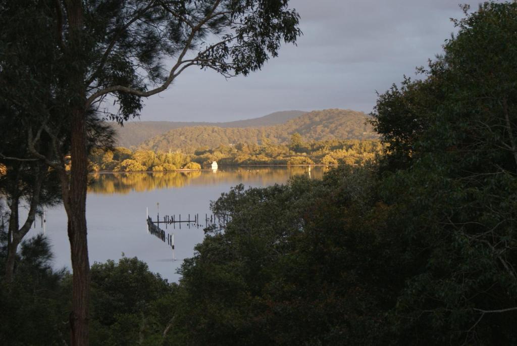 Blue Gum Cottage on Bay في Bensville: اطلالة على بحيرة مع مرسى في الماء