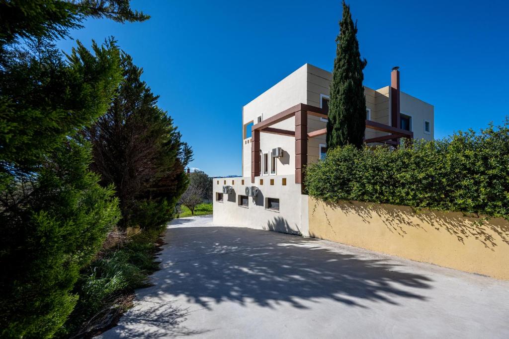 a house with a tree on the side of a road at Mayas House Greece Rhodes Kremasti in Kremasti