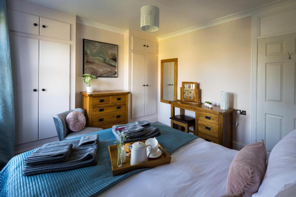 Un dormitorio con una cama y una bandeja. en Cherry Tree Villa, en Harrogate