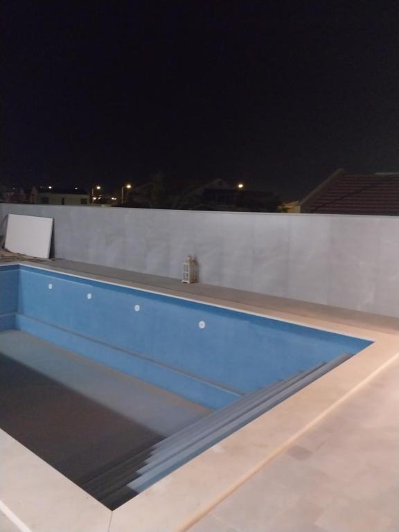a swimming pool on a roof at night at May resort in Eilat