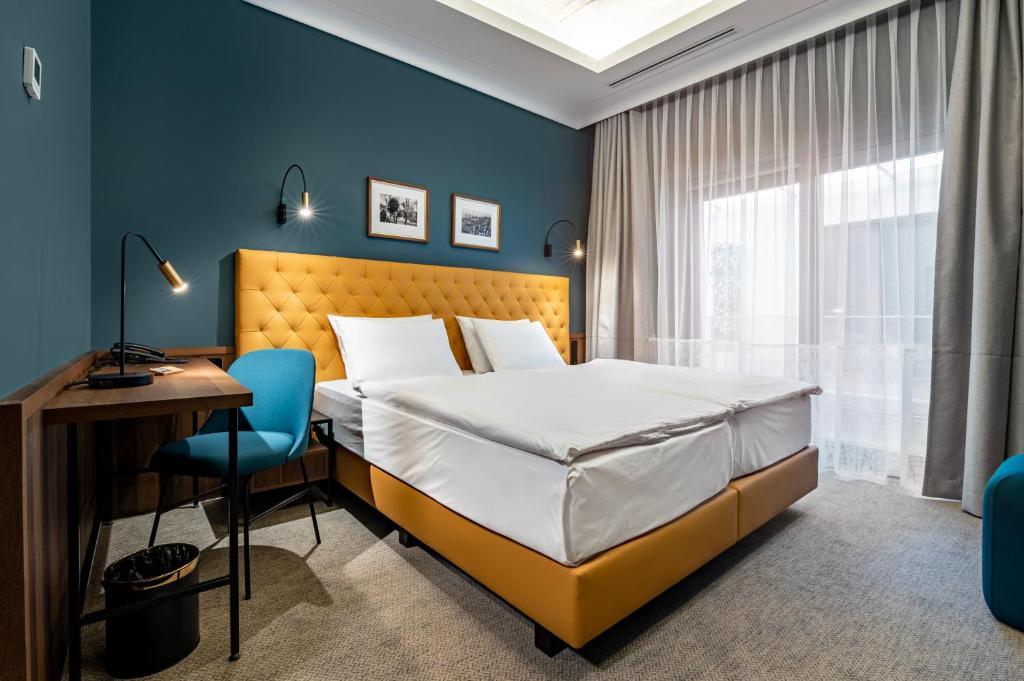 Postel nebo postele na pokoji v ubytování Palatinus Boutique Hotel