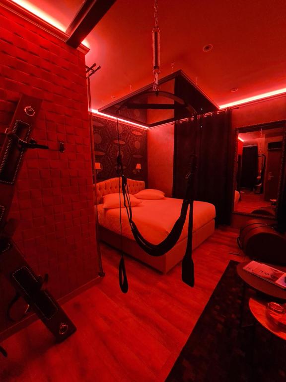 a room with a bed in a red room at LOVE ROOM - Luxembourg in Luxembourg