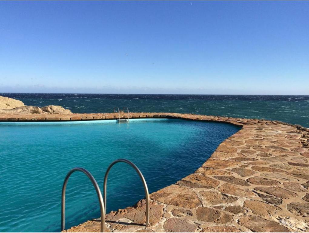 a swimming pool in the middle of the ocean at Cap Sa Sal suites -Apartament Begur - Costa Brava in Begur