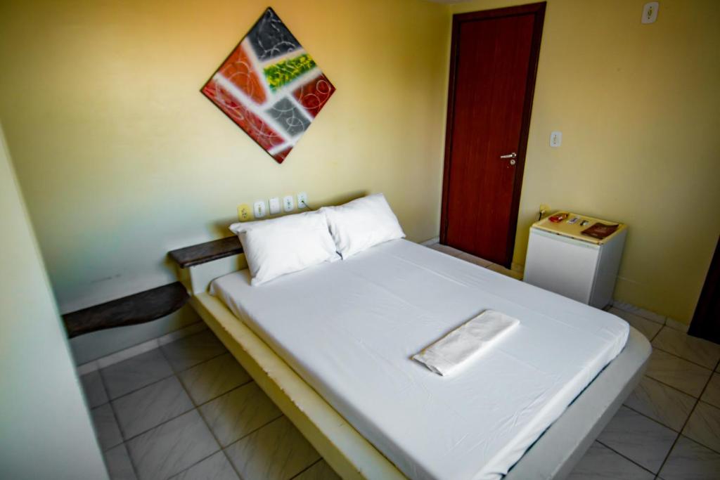 Postel nebo postele na pokoji v ubytování Hotel Piramide Pituba - Av Paulo VI