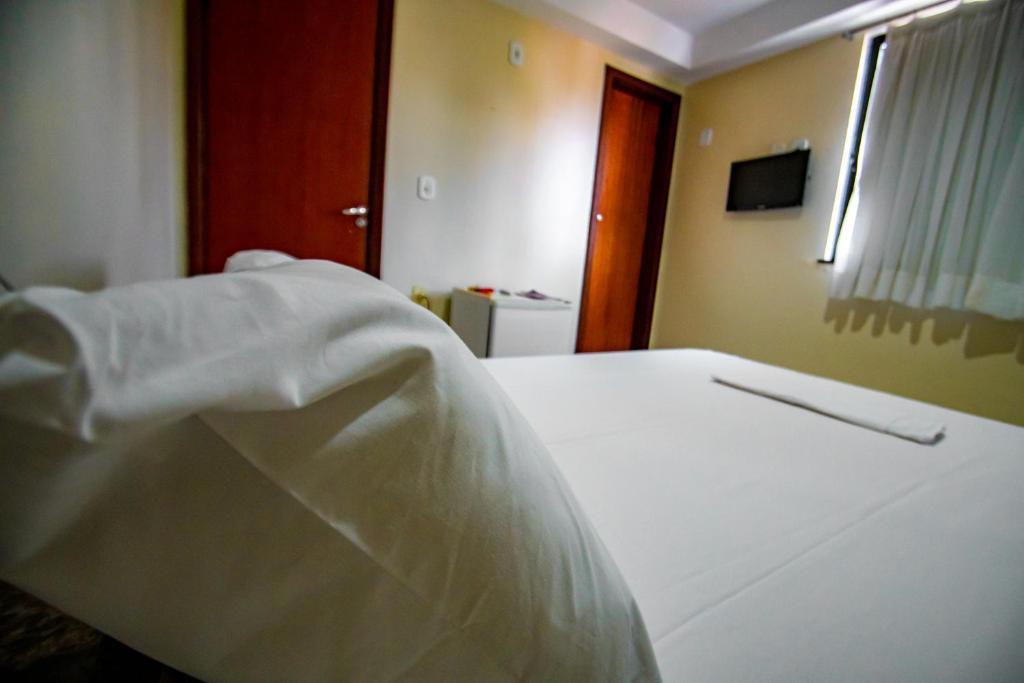 Postel nebo postele na pokoji v ubytování Hotel Piramide Pituba - Av Paulo VI