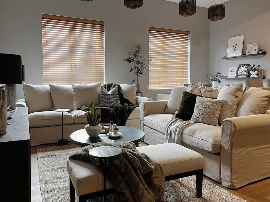 a living room with couches and a coffee table at Modern Ground Floor Apartment in Todmorden