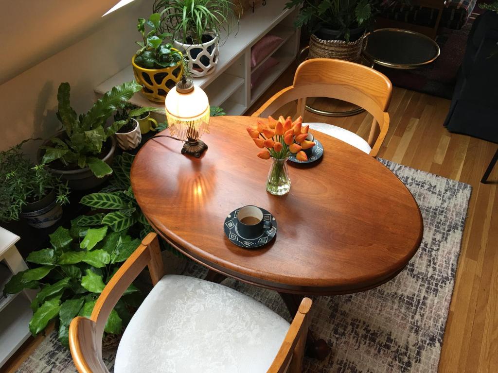 a wooden table with a vase of flowers on it at Urban Oasis in Hope Village in Providence