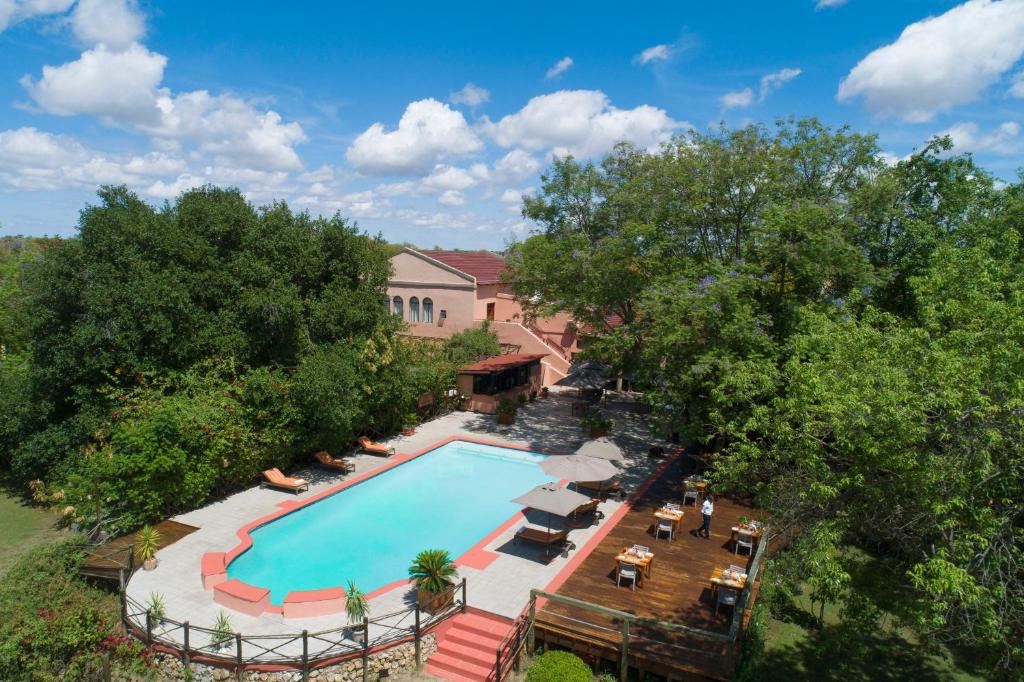 an overhead view of a swimming pool with trees at Sedia Riverside Hotel in Maun