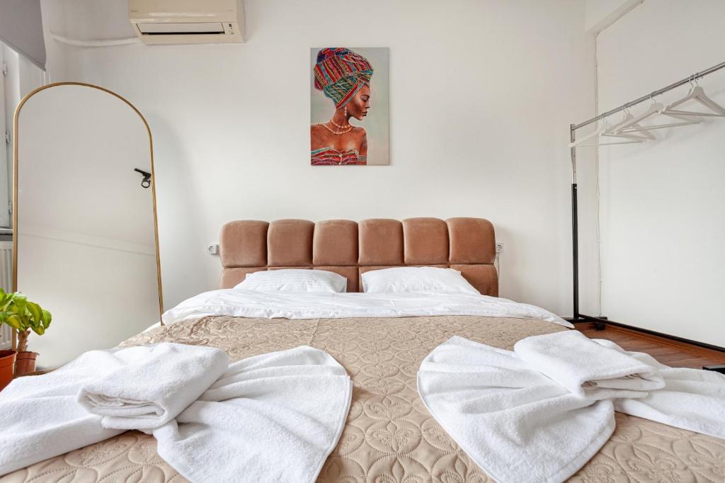 a bedroom with a large bed with towels on it at Origine rentals z3 3BR/2BA Lalely/Aksaray in Istanbul
