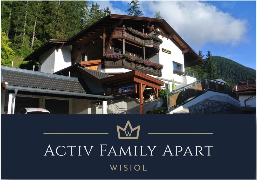 a sign for aania family apartment in front of a house at Activ-Family-Apart-Wisiol-Pitztal Sommercard inklusive in Jerzens