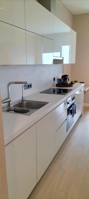 a kitchen with white cabinets and a sink at ‌skyland in Istanbul