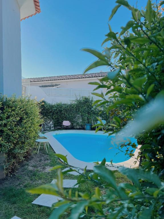 a swimming pool in front of a building at Luna House & Cowork in Cascais
