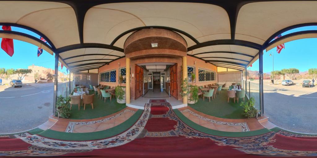 a view of a building with tables and chairs at Hotel Saint Antoine in Tafraoute