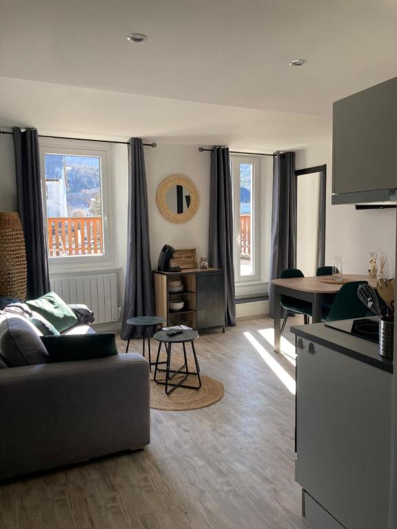 a living room with a couch and a table at Le Gaudissart 2 in Barcelonnette