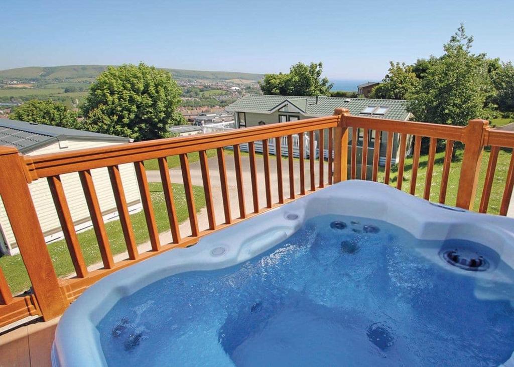 a hot tub on the deck of a house at Swanage Coastal Park in Swanage
