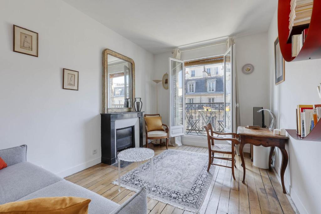 a living room with a couch and a table at Ideal 1 Bd Flat with Balcony - Paris 05 in Paris