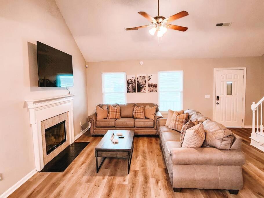 a living room with a couch and a fireplace at Percy Priest Lake2 Quiet Family Home in La Vergne