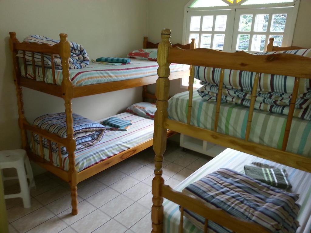 a bedroom with two bunk beds and a window at Way Up Hostel in Florianópolis