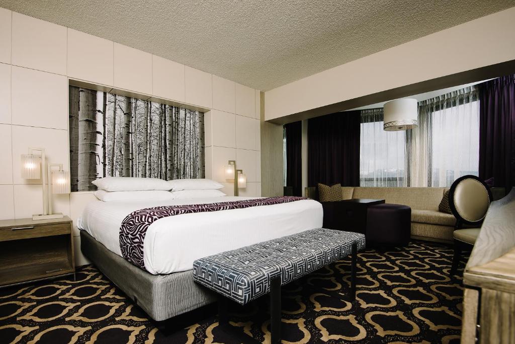 a hotel room with a bed and a couch at Harrah's Lake Tahoe Hotel & Casino in Stateline