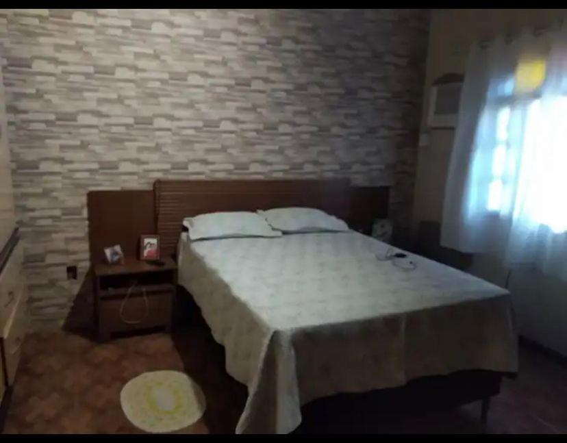 Een bed of bedden in een kamer bij Flavia Aluguel Temporada