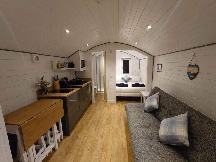 a kitchen and living room in a tiny house at Loch Shiel Luxury Pod in Acharacle