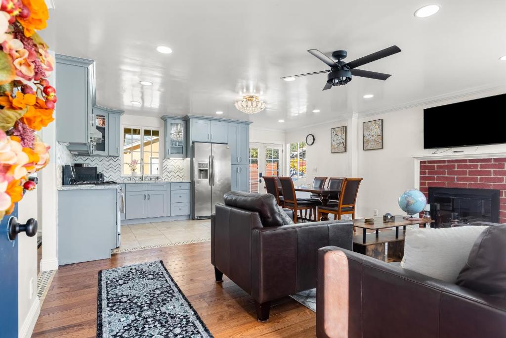 a living room with a couch and a kitchen at Goleta Getaway in Santa Barbara