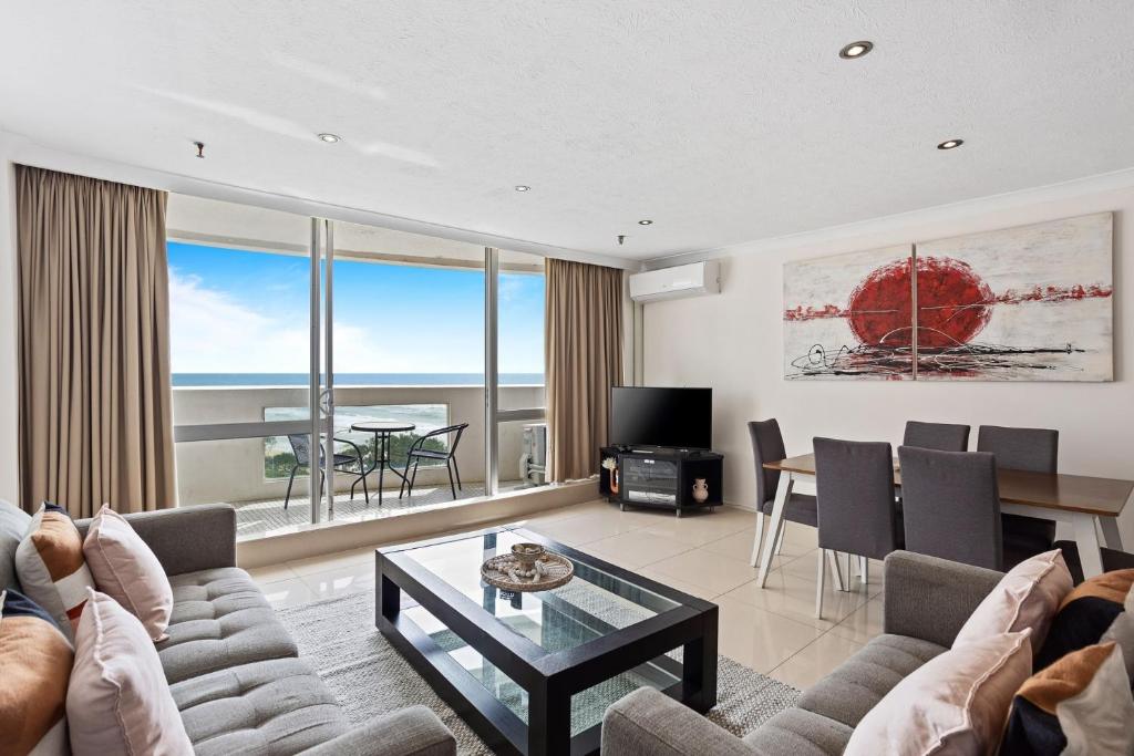 a living room with a couch and a table at Focus Apartments With Ocean Views in Gold Coast