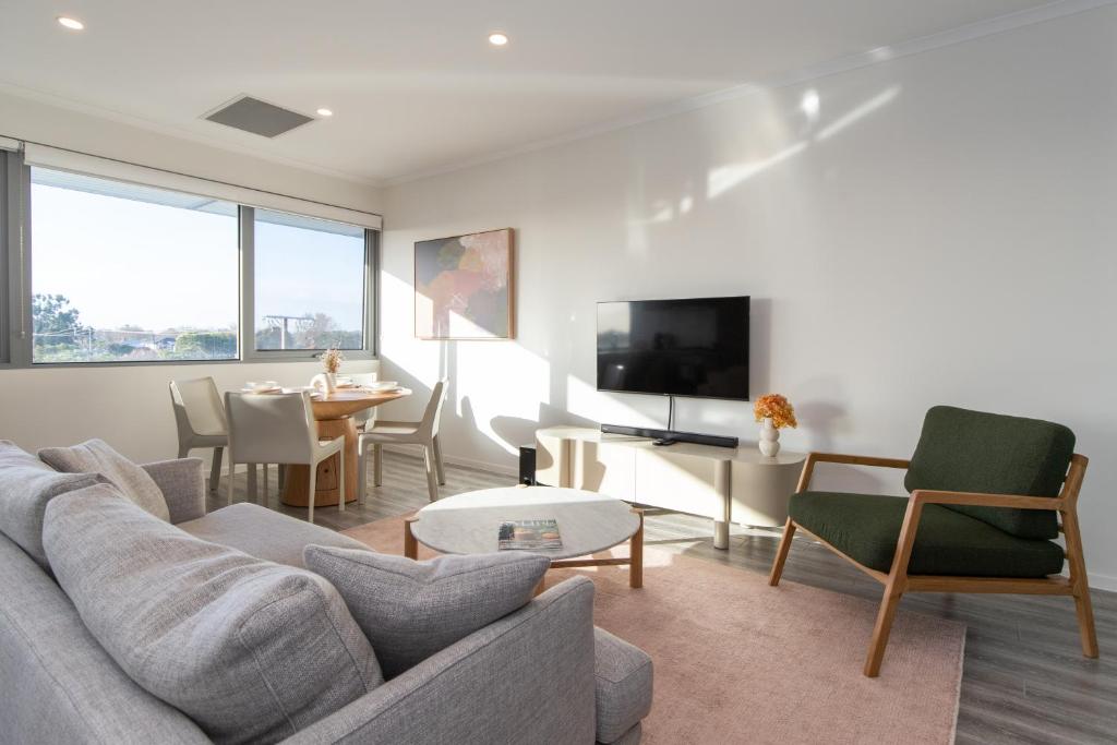 a living room with a couch and a table at Hilton Executive Apartments in Keswick