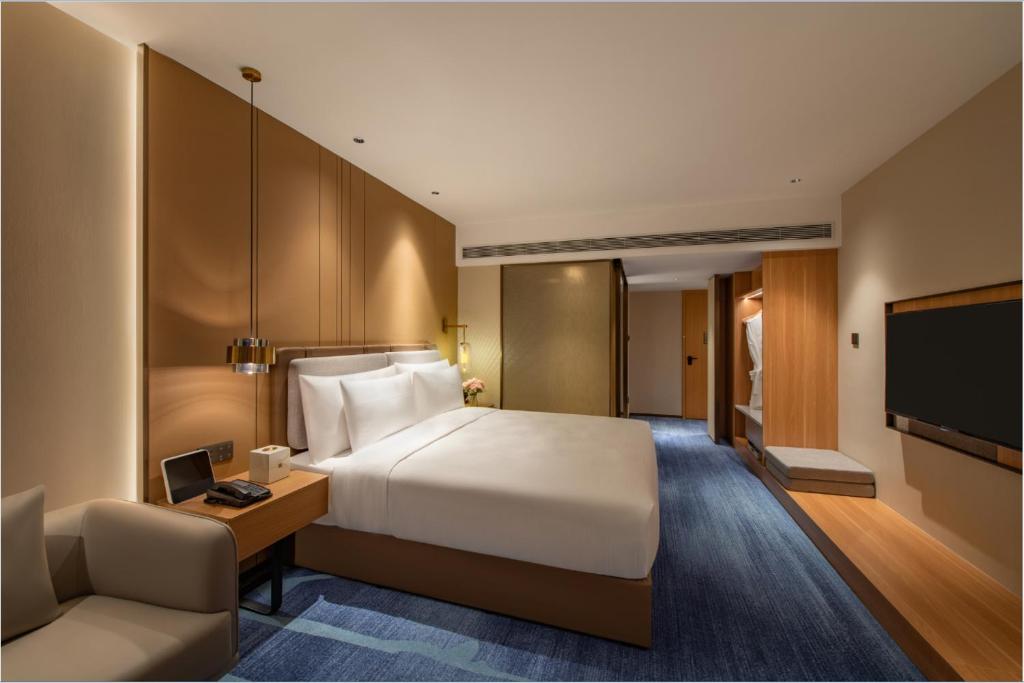 Postel nebo postele na pokoji v ubytování Guangzhou Hotel