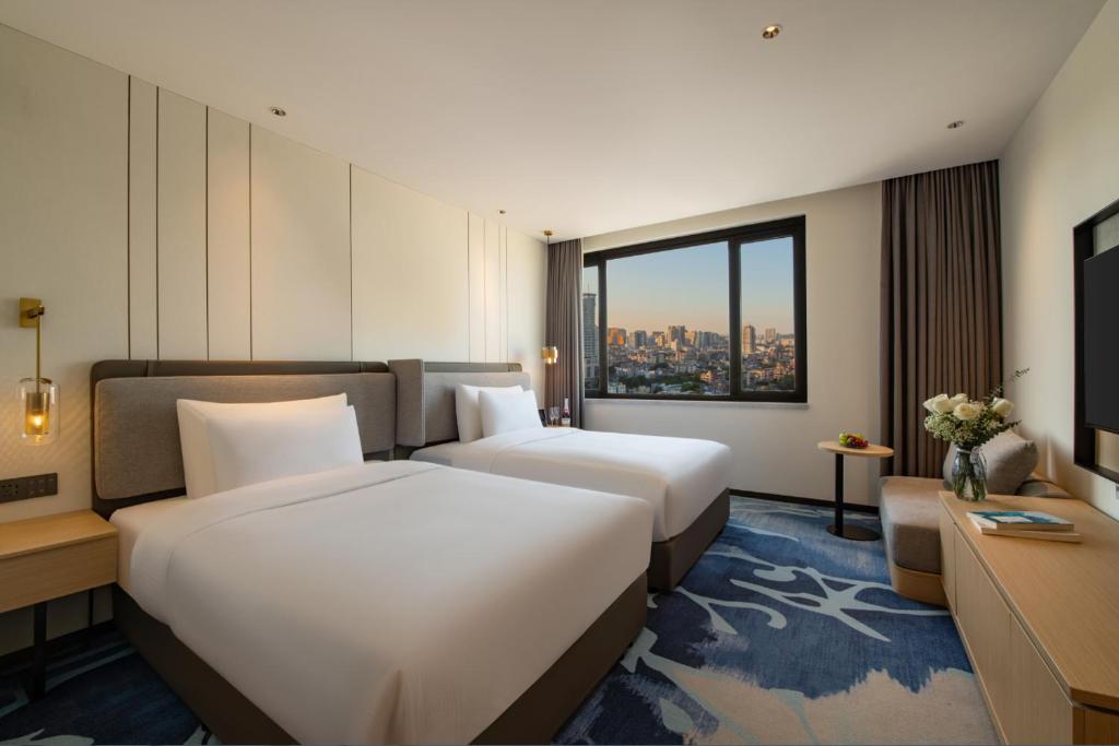 Postel nebo postele na pokoji v ubytování Guangzhou Hotel