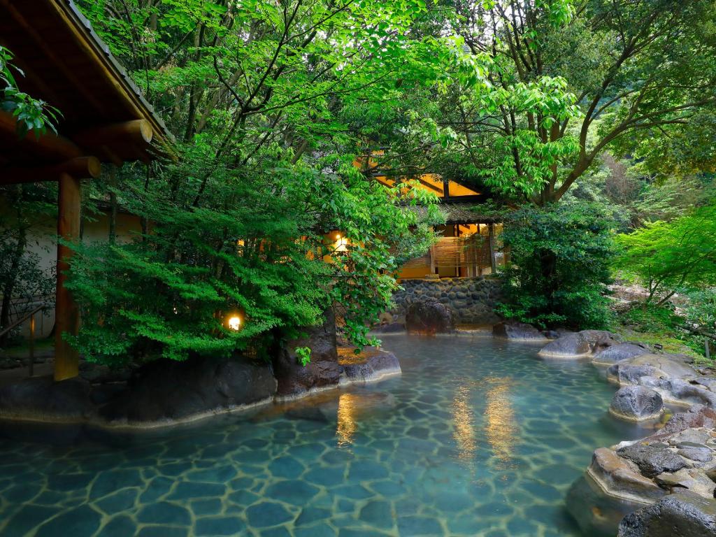 a swimming pool in the middle of a garden at Taishoya in Ureshino